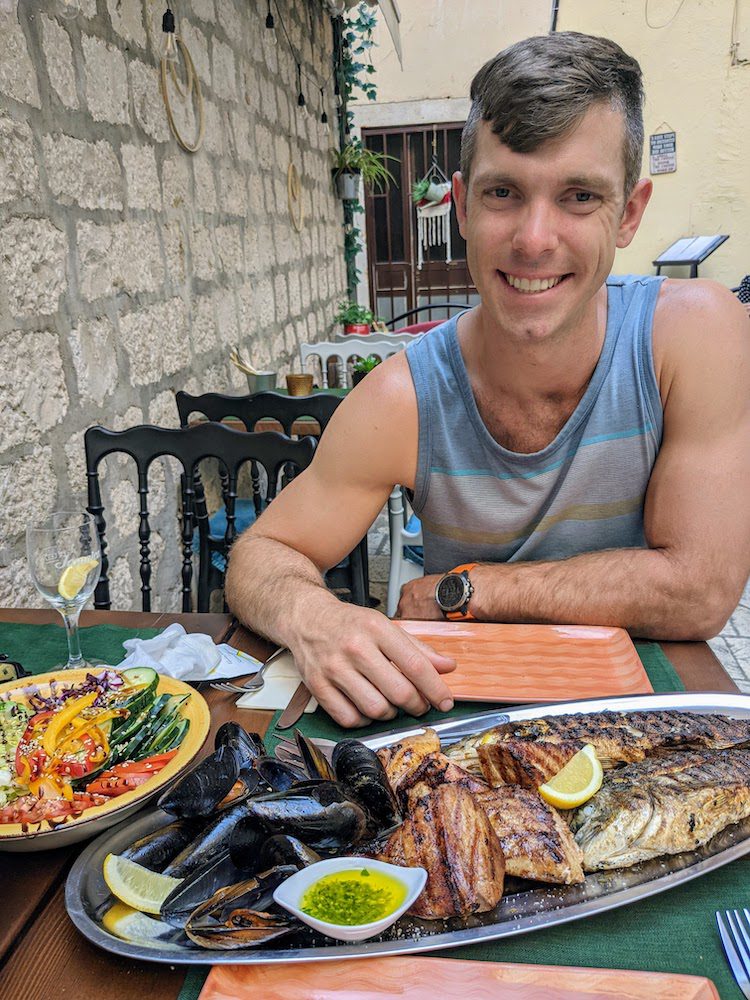 Man with the fish platter for two at Muma in the old town of split, croatia