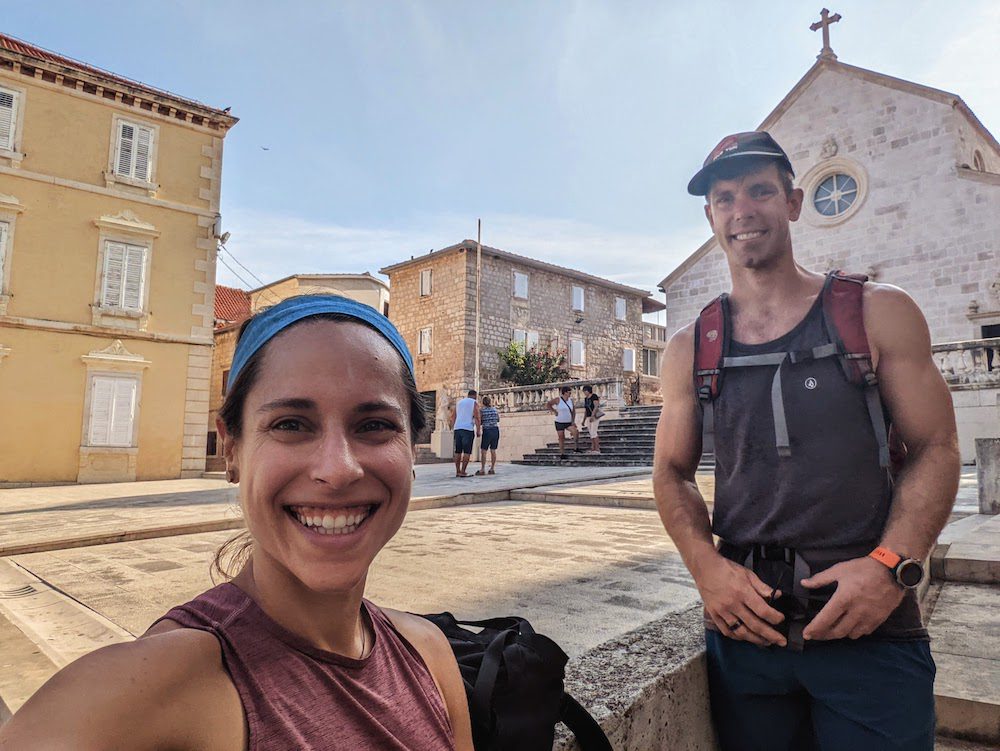 a couple in front of a church in supetar on Brač