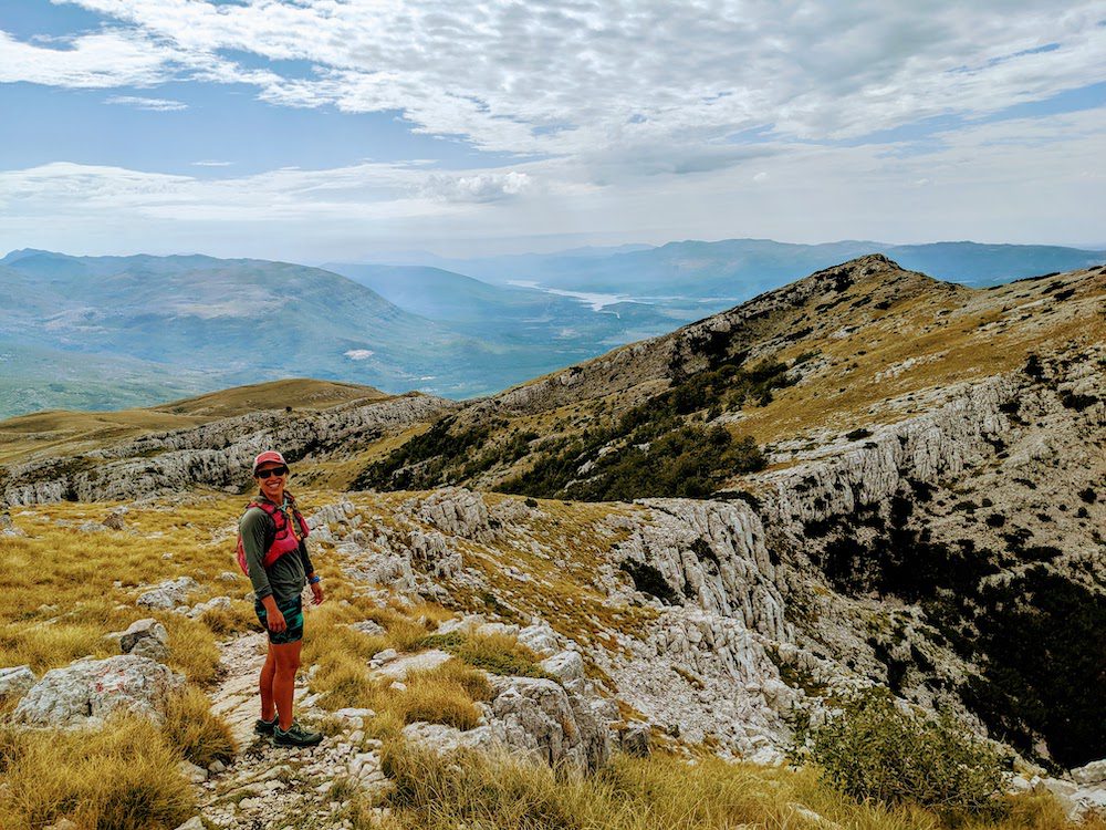 A happy woman just after summiting Dinara