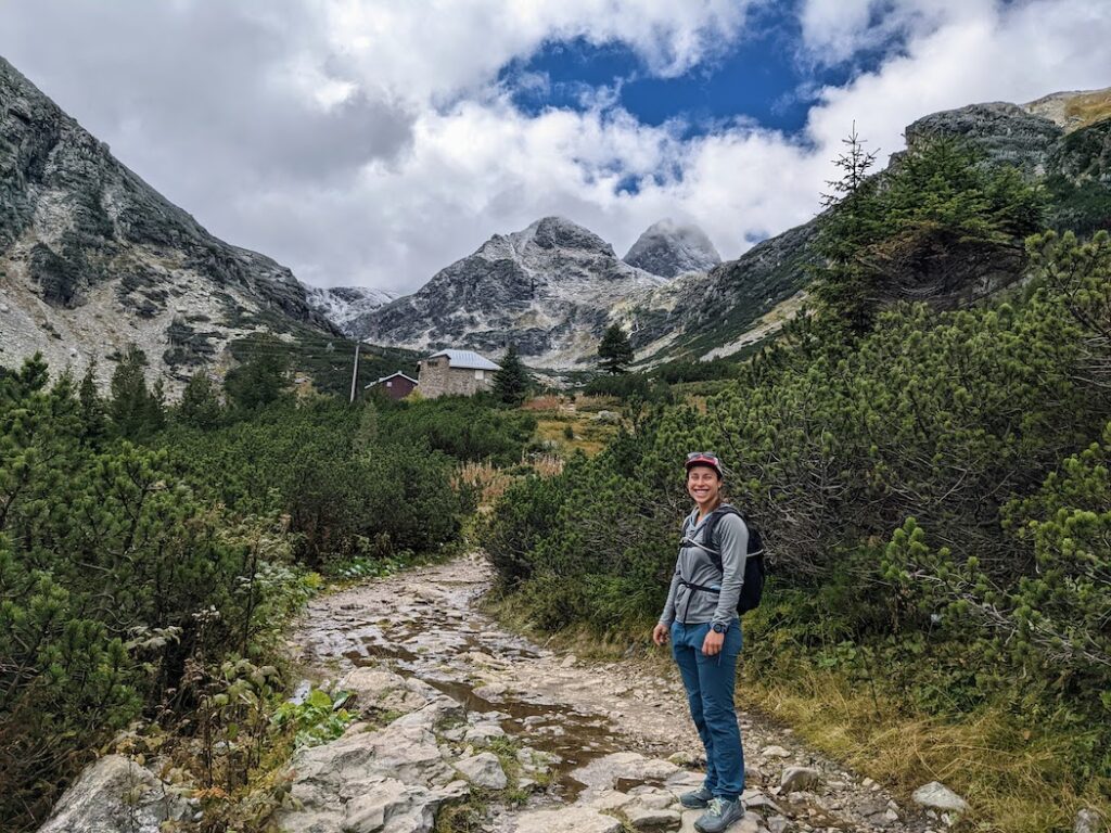 woman enjoying the craggily peaks of rila national park, bulgaria