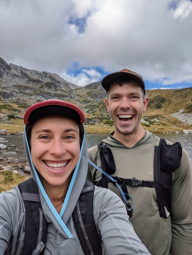 a couple enjoying a hike near a lake in rila national park bulgaira