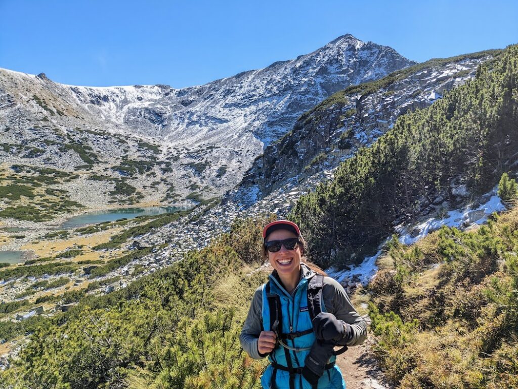 woman hiking near the snowy musala mountain in bulgaria