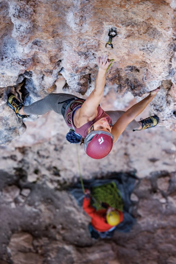 Rose rock climbing, reaching for a clip at Mars Sector in Leonidio