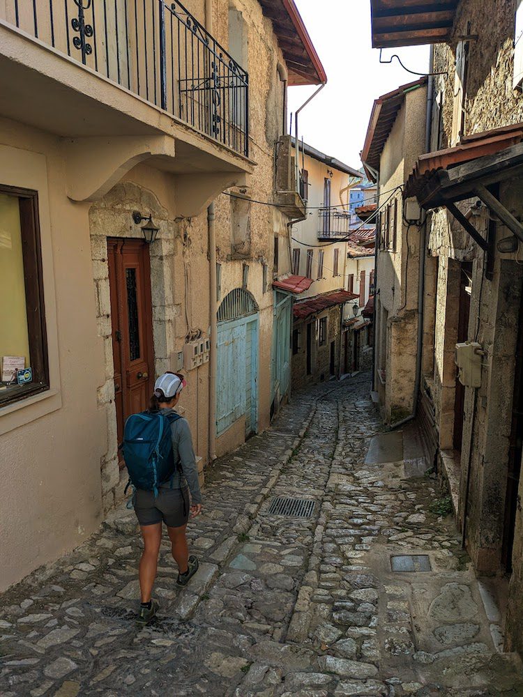 woman walking through Dimitsana at the start of our second day on the Menalon Trail