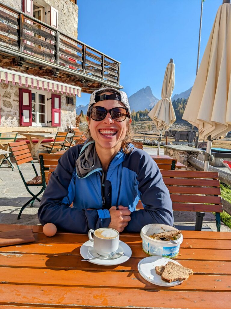 woman drinks coffee at a hut